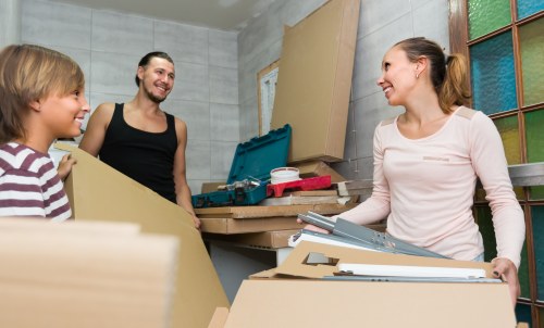 Removal team handling moving boxes in Knightsbridge home