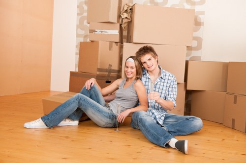 Professional movers preparing fragile items for transport