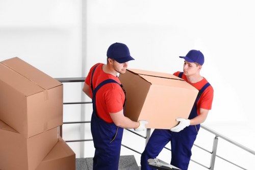 Removal crew using protective equipment while loading furniture